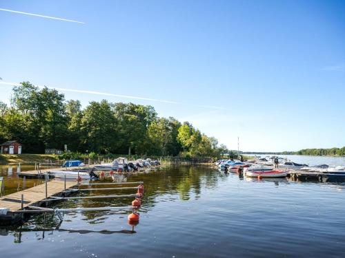 a group of boats docked at a dock on a lake at Holiday Home Stenlycke by Interhome in Ivö