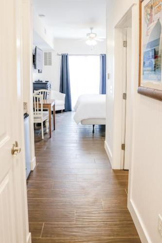 a room with a bed and a table and a kitchen at Stormy Point Village Lakeside in Branson