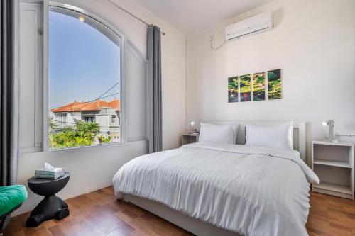 a bedroom with a bed and a large window at 3BR Villa Naga Sanur in Denpasar