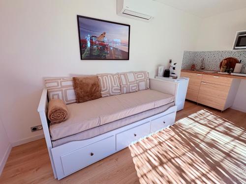 a white couch in a living room with a rug at Oasis in Ambonil