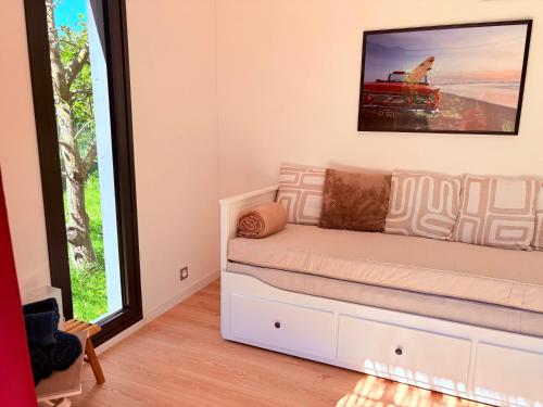 a living room with a couch and a window at Oasis in Ambonil