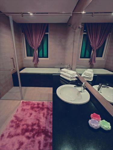 a bathroom with a sink and a bath tub at SUN House in Phu Quoc