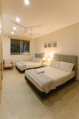 a bedroom with two beds in a room at Casa Campestre - Pet Friendly - Green Energy in Anapoima