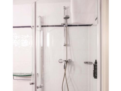 a bathroom with a shower with a shower head at Ibis Valladolid in Valladolid