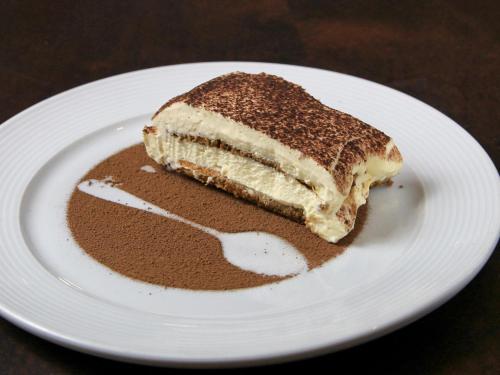 a piece of cake on a white plate at Mercure Sao Paulo Vila Olimpia in São Paulo