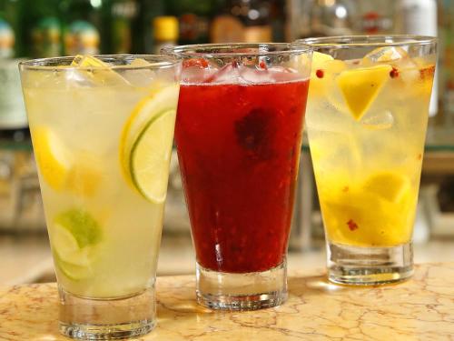 three cocktails in glasses sitting on a table at Mercure Sao Paulo Vila Olimpia in São Paulo