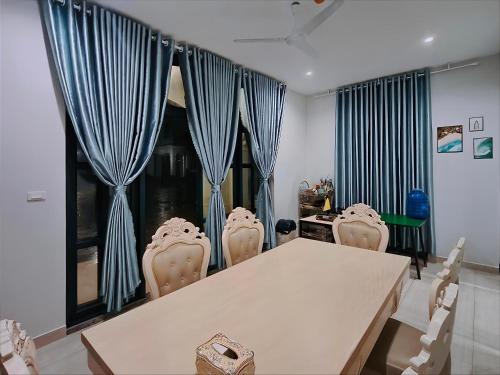 a dining room with a table and chairs at SUN House in Phu Quoc