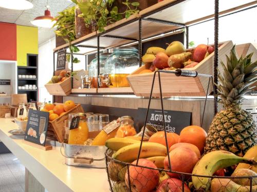 a store with a bunch of fruit on a counter at Ibis Sevilla in Seville