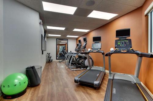 a gym with exercise equipment and a green helmet in a room at Drury Inn & Suites Knoxville West in Knoxville
