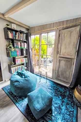 a living room with a blue bean bag chair and a book shelf at Holiday Home Ferienhaus Inge & Henry an der Werra by Interhome in Altenburschla