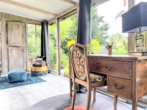 a home office with a desk and a large window at Holiday Home Ferienhaus Inge & Henry an der Werra by Interhome in Altenburschla