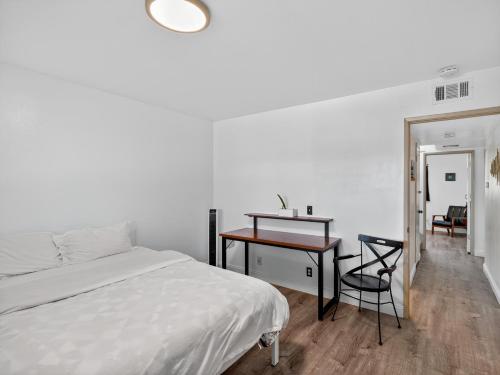a bedroom with a bed and a desk and a table at Coastal Escape with Private Mini Golf home in Hollywood Beach