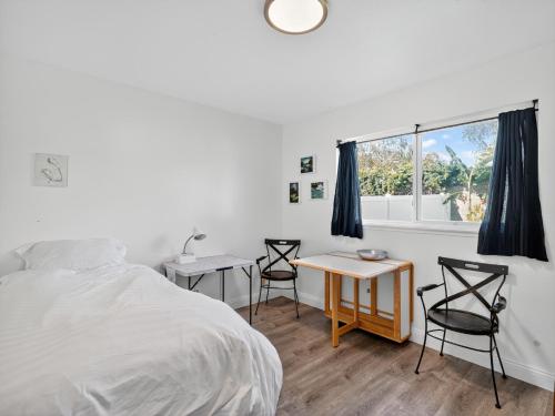 a bedroom with a bed and two chairs and a table at Coastal Escape with Private Mini Golf home in Hollywood Beach