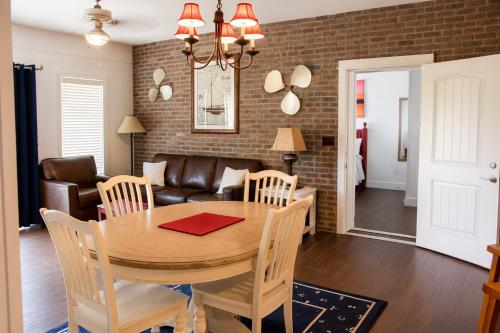 a dining room and living room with a table and chairs at Stormy Point Village Lakeside in Branson