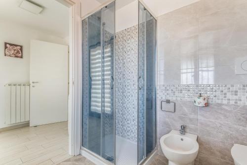 a bathroom with a shower and a toilet and a sink at Elegante Appartamento con Comfort Completi vicino a Mezzi & Servizi in Bareggio