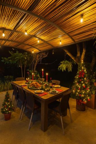 a wooden table with christmas trees and candles on it at Casa Campestre - Pet Friendly - Green Energy in Anapoima