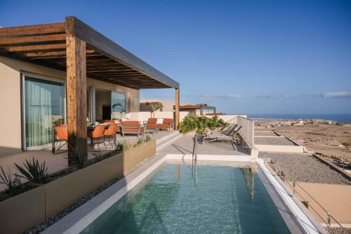 a house with a swimming pool on a balcony at Kaiman Suites in Salobre