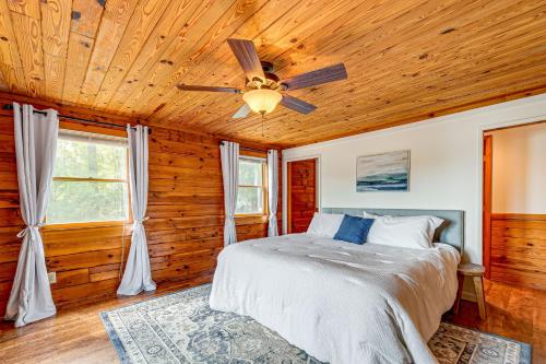 a bedroom with a bed and a ceiling fan at Hyco Lake Escape with Deck and Dock Families Welcome! in Semora