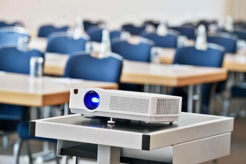 a computer monitor sitting on a table in a classroom at NH Mannheim Viernheim in Viernheim