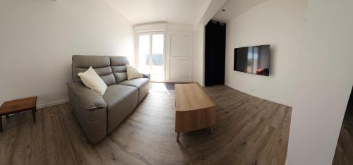 a living room with a couch and a coffee table at Villa-appartement de 70 m2 à Agde in Agde
