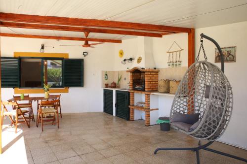 a living room with a chair and a table at Villa Rosa in Corroios