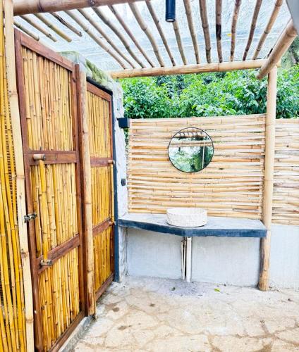 a blue bench sitting next to a wooden fence at Alma Glamping in Coatepec