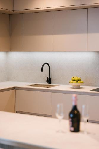 a kitchen with a sink and a bowl of fruit and a bottle of wine at Salobre Homes in Salobre