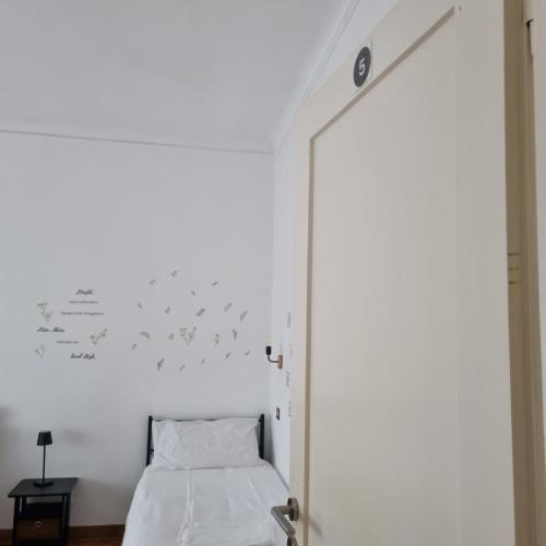 a bedroom with a bed and a wall with birds on it at Dock Bay Lodge Hostel in Trieste