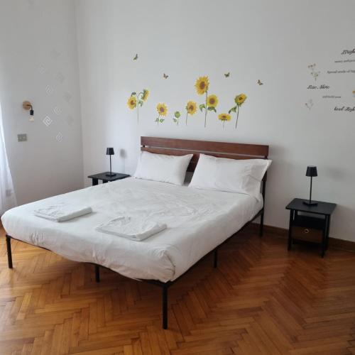 a bedroom with a bed with two tables and two lamps at Dock Bay Lodge Hostel in Trieste