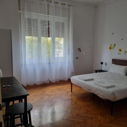a bedroom with a bed and a large window at Dock Bay Lodge Hostel in Trieste