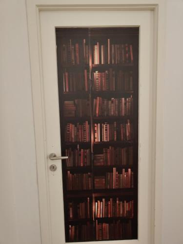 a book shelf filled with lots of books at Dock Bay Lodge Hostel in Trieste