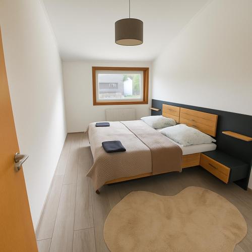a bedroom with a large bed and a window at Koblenz Exclusive Residence in Koblenz