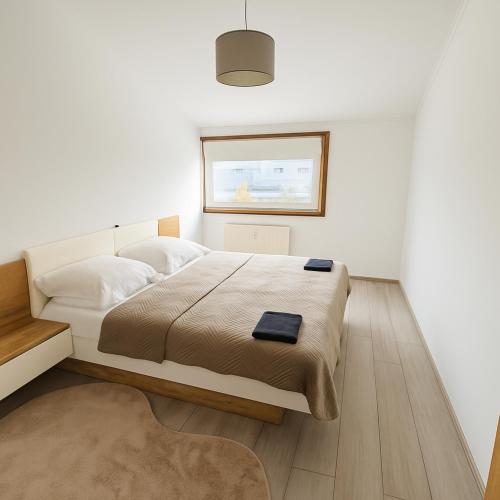 a white bedroom with a large bed and a window at Koblenz Exclusive Residence in Koblenz