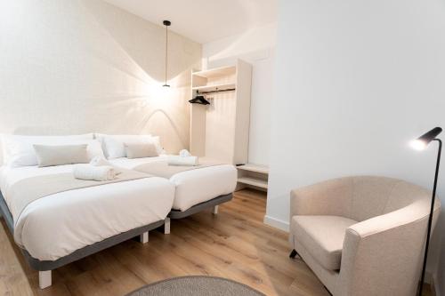 une chambre avec un lit et une chaise dans l'établissement TeruelHOME GOLD, à Teruel