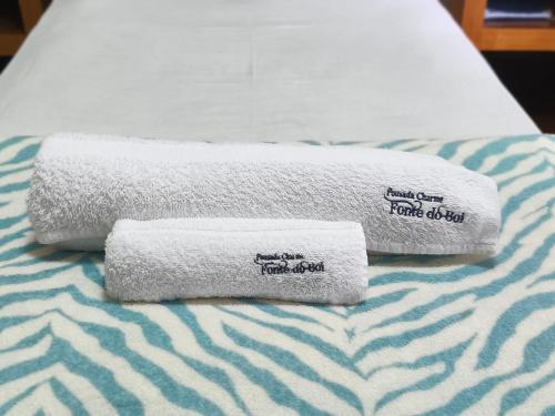 two towels sitting on top of a bed at Hotel Charme Fonte do Boi in Salvador