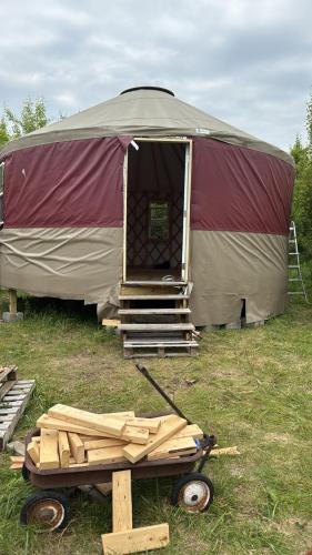 a large tent with a pile of wood in front of it at Fazenda Neuchatel in Guaratinguetá