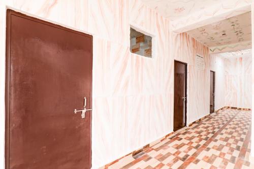 an empty room with a door and a tiled floor at Hotel O BRS Dream in Hasanganj