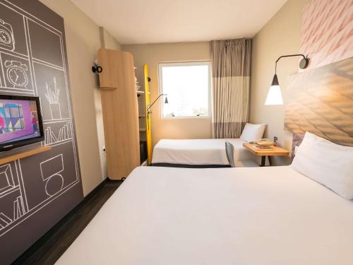 Ένα ή περισσότερα κρεβάτια σε δωμάτιο στο ibis Ribeirao Preto Shopping
