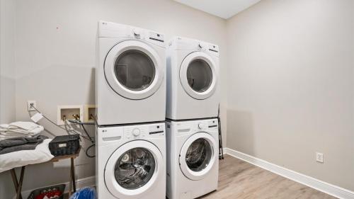 two washing machines are in a laundry room at Tranquil 1 BR Studio in Grand Bay - Oak & Fountain in Grand Bay