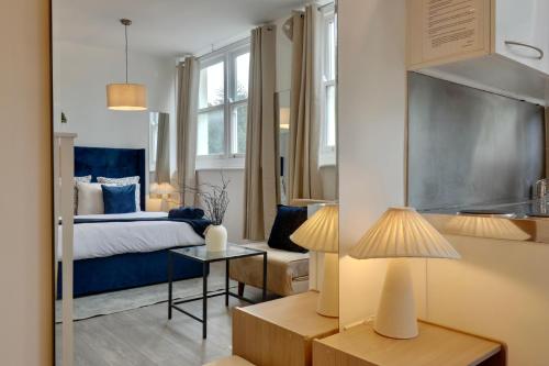 a bedroom with a bed and a table with a lamp at Stylist Ground-Floor Studio Near City Centre in Portsmouth