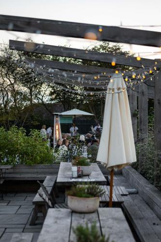 a patio with an umbrella and a table with at The Five Bells Inn in Brabourne