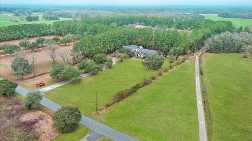 an aerial view of a field with a house and a road at Tranquil 1 BR Studio in Grand Bay - Oak & Fountain in Grand Bay