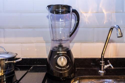 a blender sitting on a counter next to a sink at My One Bela Vista in Sao Paulo