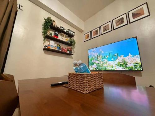 a living room with a television and a table at Casa Josefina in Manila
