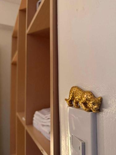 a gold figurine of a dog on top of a refrigerator at Casa Josefina in Manila