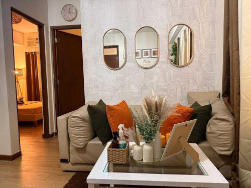 a living room with a couch and mirrors on the wall at Casa Josefina in Manila