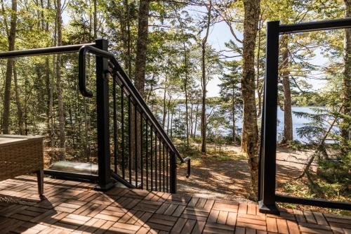 a wooden deck with a view of the water at Sunken Escapes Glamping Unit #2 in New Minas