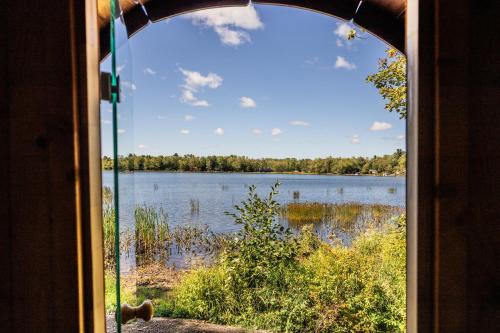 a view of a lake through a window at Sunken Escapes Glamping Unit 5 in New Minas