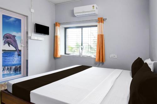 a bedroom with a bed and a window at Hotel O Dream Land in Khandagiri