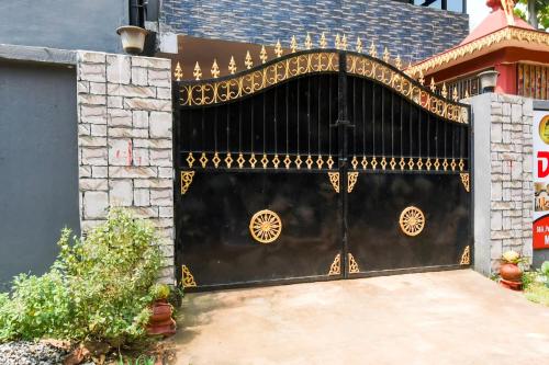 a black gate with gold designs on it at Hotel O Dream Land in Khandagiri